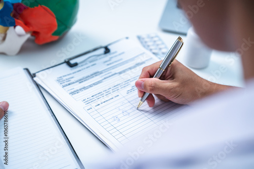 Doctor is dispensing medicine about brain tumor, neurology trauma or stroke. Professional senior doctor diagnose head pain or skull injury and list out to name of medicine for patient.