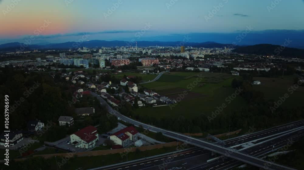Aerial hyperlapse of a cars on a highway, heavy traffic at sunset by the city Ljubljana Aerial hyperlapse of a cars on a highway, heavy traffic at sunset by the city Ljubljana