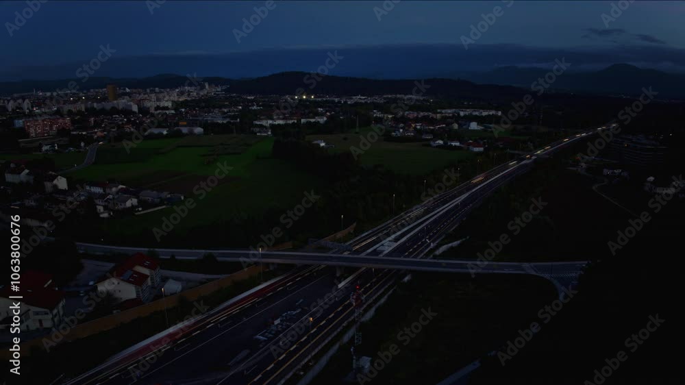 Aerial hyperlapse of a cars on a highway, heavy traffic at sunset by the city Ljubljana Aerial hyperlapse of a cars on a highway, heavy traffic at sunset by the city Ljubljana
