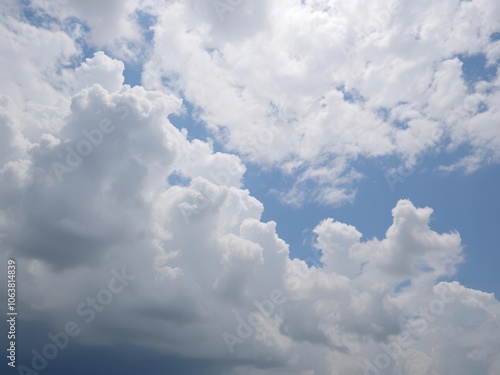 Clear blue sky filled with fluffy white clouds, creating a peaceful and serene atmosphere, sky, peaceful, fluffy