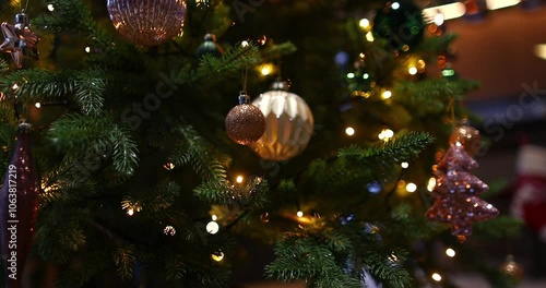 Christmas tree with toys and illumination lights in home interior. Holiday decoration