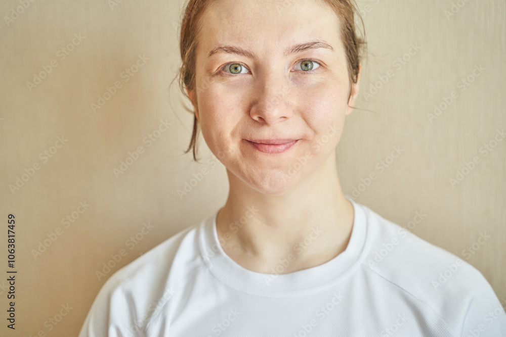 Confident young woman smiling in casual white top against neutral background. Confident young woman smiling in casual white top against neutral background.