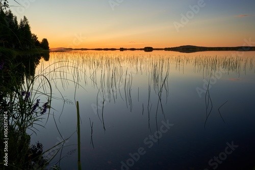 Serene lakeside scene at sunset in Kemijarvi, Lapland, Finland photo