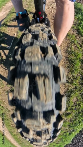 Rolling mountain bike wheel on gravel road