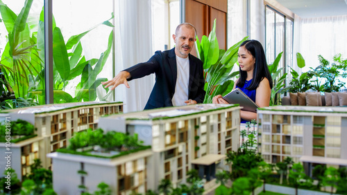 A real estate manager in the office shows the layout of the apartment and advises the client on purchase, rental and mortgage issues. Concept of buying or renting real estate. photo