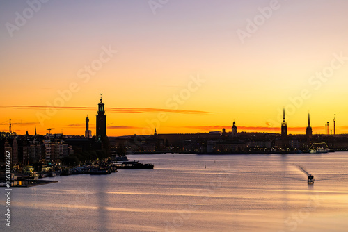 Photography Stockholm, Sweden A boat in the early morning and a skyline silhouette of the city with the City Hall