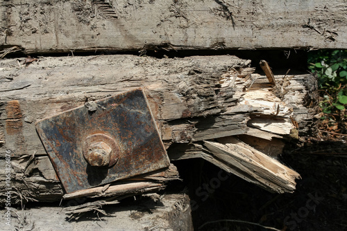 Splintering wood found in an abandoned area near a Ghost Town in Washington State. Has a large metal plate on the front, with a splintering break on the end. photo