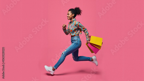 Stylish Young Woman in Vibrant Outfit Running on Pink Background: Perfect for Fashion Retail Ads and Lifestyle Blogs