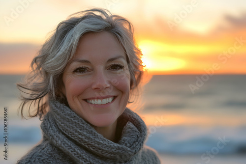 Portrait of a joyful woman in her 40s in a wool sweater against a beach sunset. 4k high quality