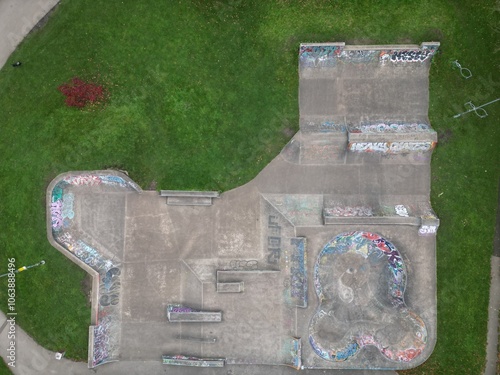 Aerial top down view of an empty skate park surrounded by trees and green grass. Taken in Hebden Bridge. 