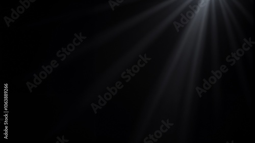 Rays of light shining abstractly in a dark background for artistic use with copy space