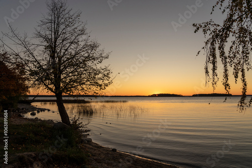 Fototapeta Naklejka Na Ścianę i Meble -  Golden sunset over Lake Sniardwy. Landscape of Masuria in Poland.