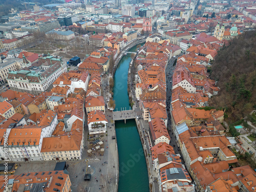 Aerial view of Ljubljana historic town with Ljubljanica river and Cobbler s Bridge or Šuštarski most in Slovenian. A pedestrian zone in city center. Ljubljana university building next to park Zvezda. photo