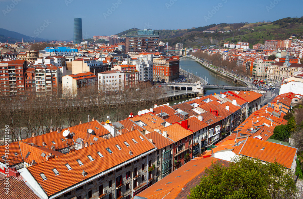 Elevated view of the skyline of Bilbao with the Nervion River at sunset