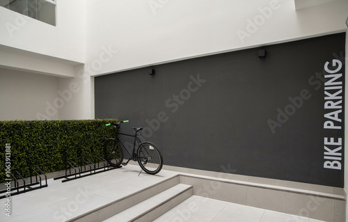 parqueadero de bicicletas dentro de edficio con rack para asegurar llantas photo