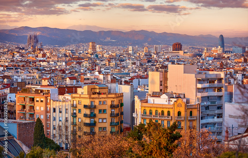 Barcelona, Catalonia, Spain. Panoramic view at the barcelone city during sunset. Evening urban panorama top of buildings and mountains far away.