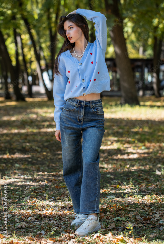 Beautiful girl in a knitted sweater, autumn park outdoors Beautiful girl in a knitted sweater, autumn park outdoors