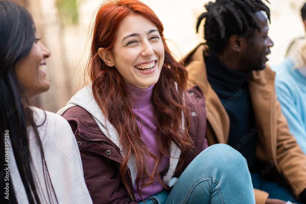 Multicultural friends sharing laughter outdoors in natural winter light - Candid portrait of diverse casual young people hangout enjoying social time together Multicultural friends sharing laughter outdoors in natural winter light - Candid portrait of diverse casual young people hangout enjoying social time together