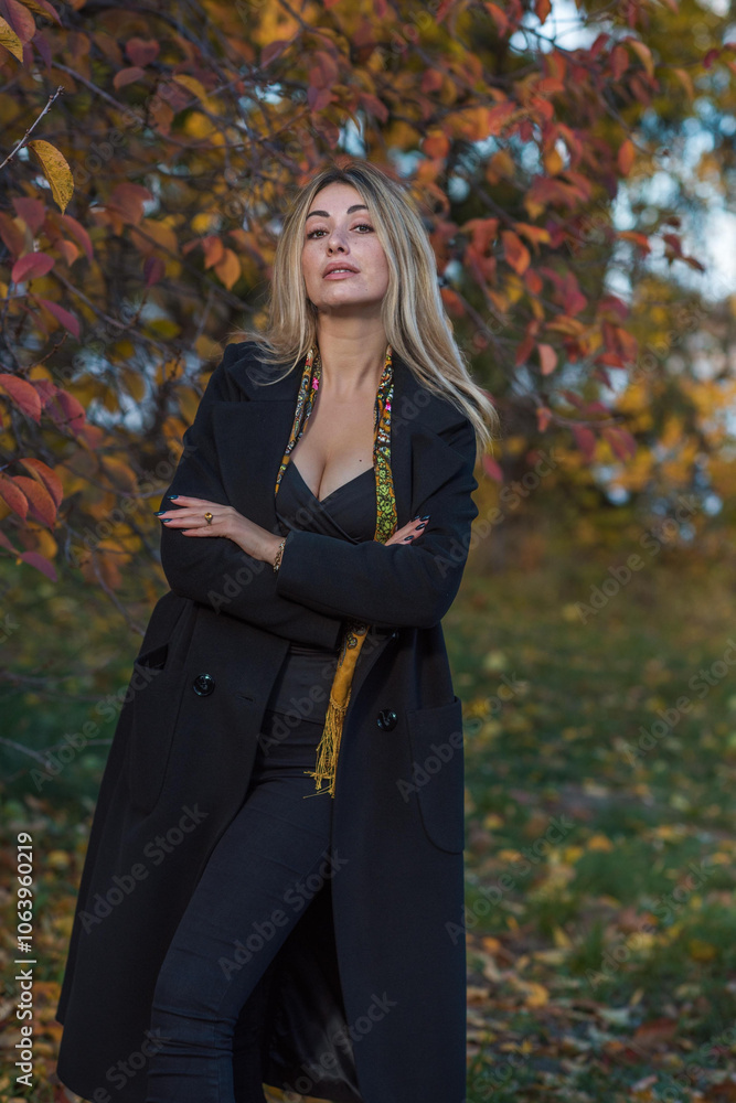 Blonde hair lady in black wool coat and golden scarf, fashionable trends for women, real photo outdoor portrait Blonde hair lady in black wool coat and golden scarf, fashionable trends for women, real photo outdoor portrait