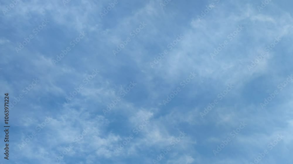 Clouds are floating in sky. Blue sky with white cirrus clouds that are moving sedately across the sky. They are located at different heights and almost do not change their shape and size as they move. Clouds are floating in sky. Blue sky with white cirrus clouds that are moving sedately across the sky. They are located at different heights and almost do not change their shape and size as they move.