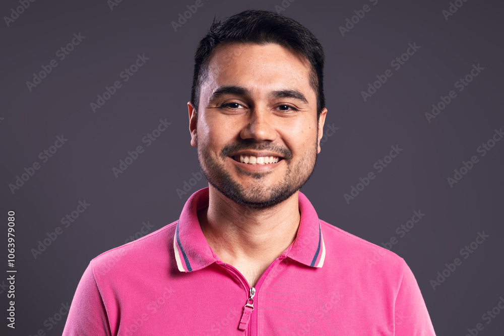 Portrait of Brazilian man wearing polo shirt in pink Portrait of Brazilian man wearing polo shirt in pink