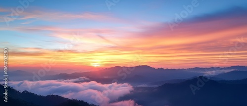 Wallpaper Mural A view of a sunset over a mountain range covered in clouds Torontodigital.ca