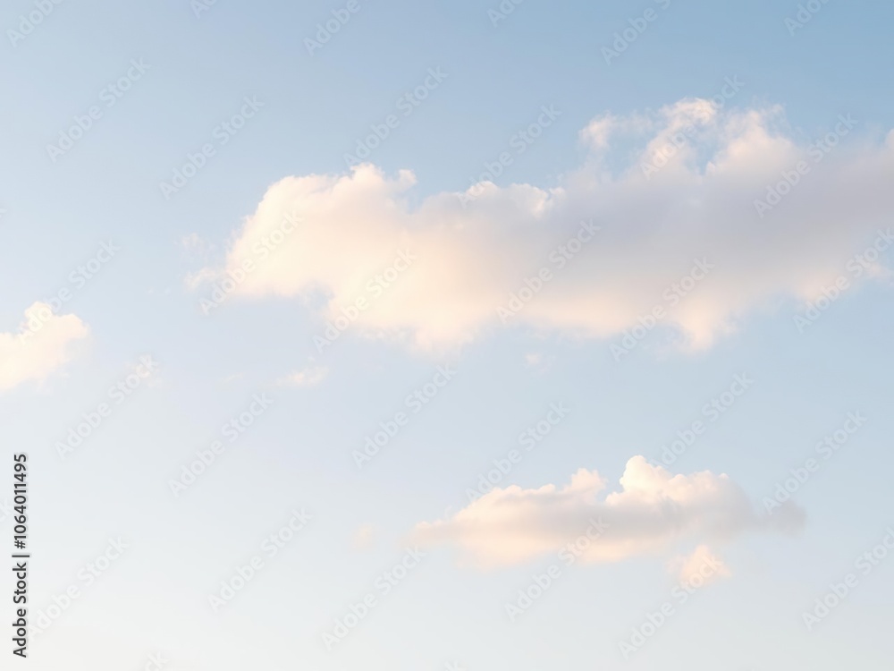 Softly glowing clouds drift across a pale blue sky, nature's canvas, soft focus, ethereal beauty Softly glowing clouds drift across a pale blue sky, nature's canvas, soft focus, ethereal beauty