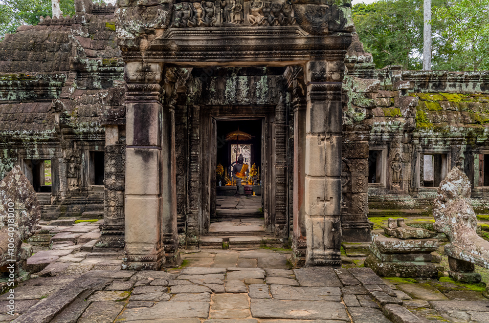 A statue of Buddha and offering at the Banteay Kdei temple in Cambodia A statue of Buddha and offering at the Banteay Kdei temple in Cambodia