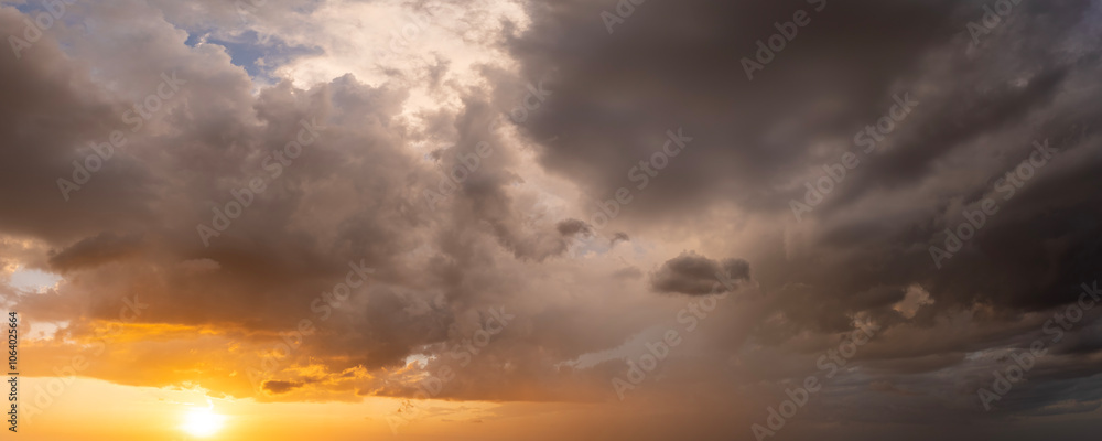 Obraz premium Stormy cumulonimbus clouds before thunderstorm on dark sunset sky. Moving and changing cloudscape weather