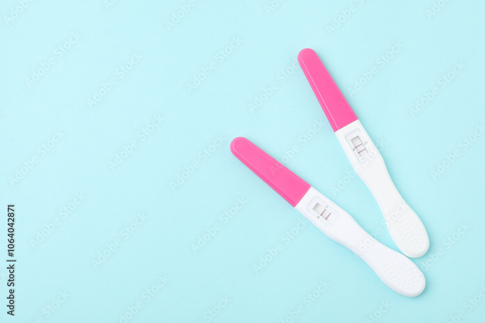 Pregnancy tests on light blue background, top view Pregnancy tests on light blue background, top view