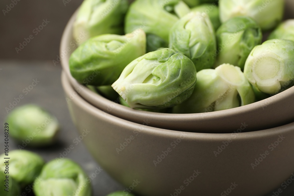 Fresh Brussels sprouts in bowl on grey table, closeup Fresh Brussels sprouts in bowl on grey table, closeup