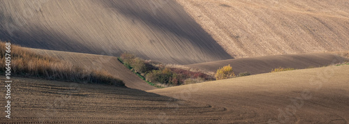 Stunning undulating arable agricultural landscape, photographed in autumn in south Moravia in the Czech Republic. The area is known as Moravian Tuscany and is full of rolling hills used for farming. photo