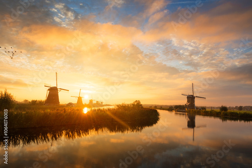 Summer morning landscape with windmills in Kinderdijk in Holland at sunrise