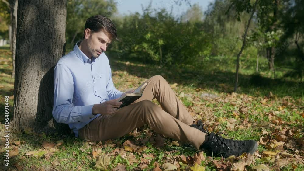 Man Enjoying a Quiet Moment Reading Outdoors by the Lake Man Enjoying a Quiet Moment Reading Outdoors by the Lake