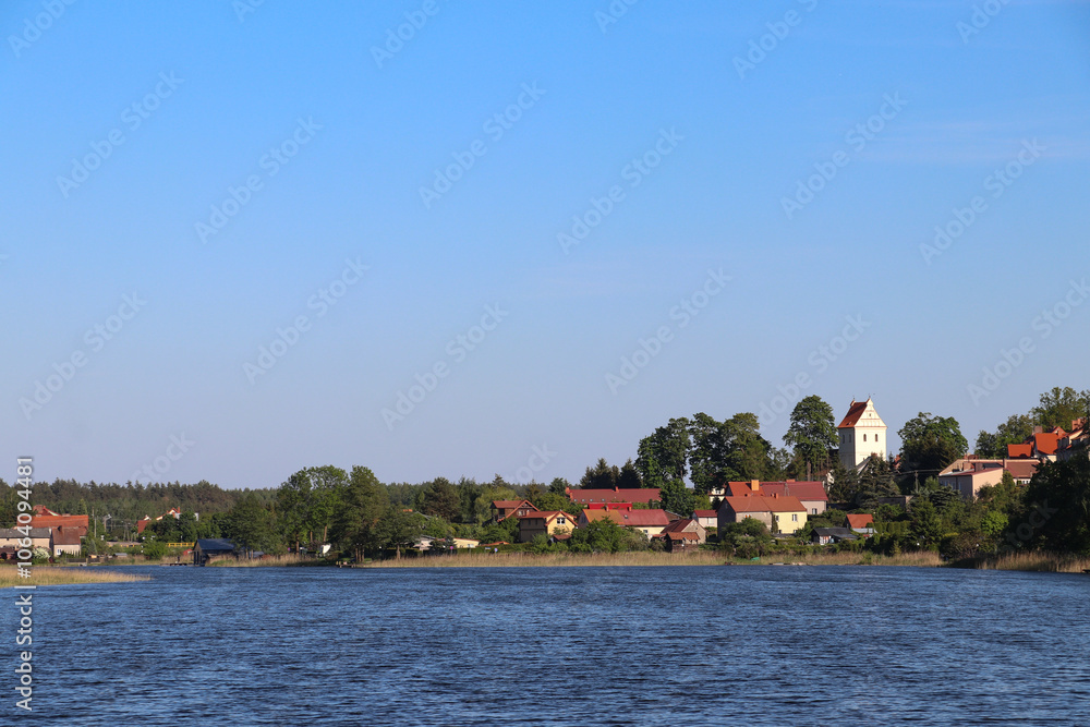 Fototapeta premium View from Lake Widmińskie towards the summer resort of Wydminy, Poland, Warmian-Masurian Voivodeship