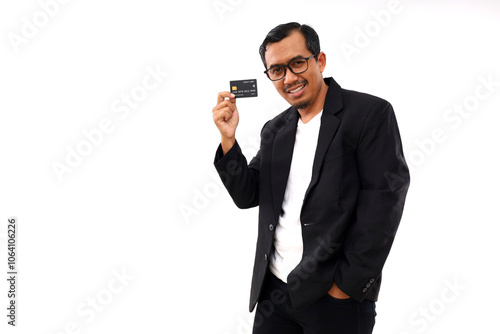 Happy Asian man in standing and showing credit card. Isolated on white background with copyspace