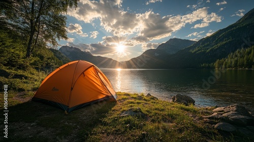 Captivating sunset over an orange tent by the lake amidst majestic mountains and lush forests