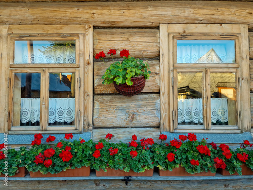 fragment wooden house built  in traditional style with flowers. Poland photo