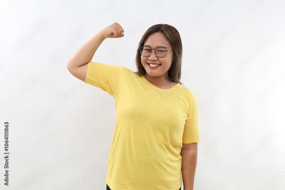 Confident young Asian woman raises hand up and shows demonstrates strength looks like strong powerful bodybuilder. isolated over white background Confident young Asian woman raises hand up and shows demonstrates strength looks like strong powerful bodybuilder. isolated over white background