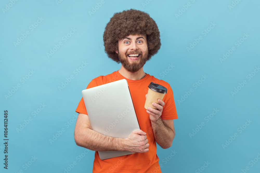 Man with notebook and takeaway coffee in hands, looking at camera with positive expression. Man with notebook and takeaway coffee in hands, looking at camera with positive expression.