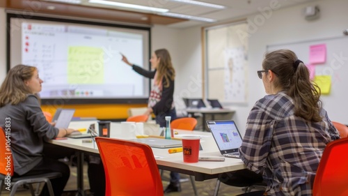 Collaborative team meeting in modern office with interactive whiteboard and digital devices