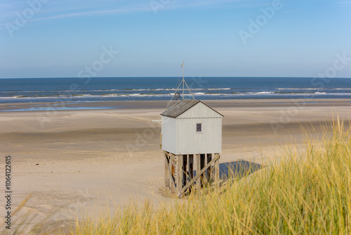 A wooden shelter on high stilts that stands on the North Sea beach (De Drenkelingenhuisje) The Dutch Wadden Sea island Terschelling, Municipality and an island in the northern, Friesland, Netherlands. photo