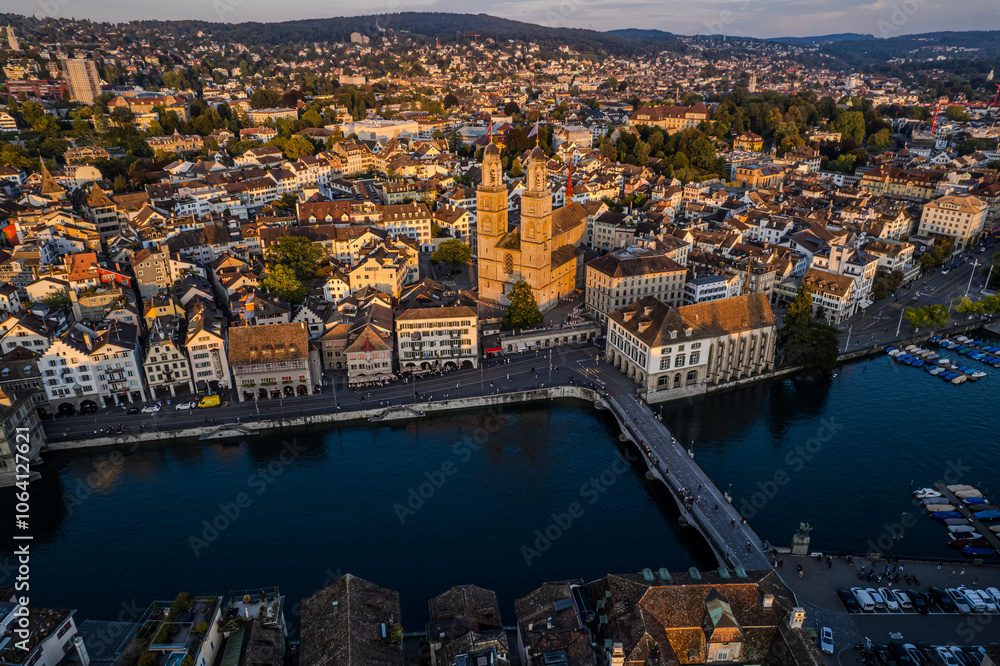 Obraz premium Beautiful aerial view of the city of Zurich in Switzerland - the Limmat River and its iconic churches, buildings rivers and Clockes.