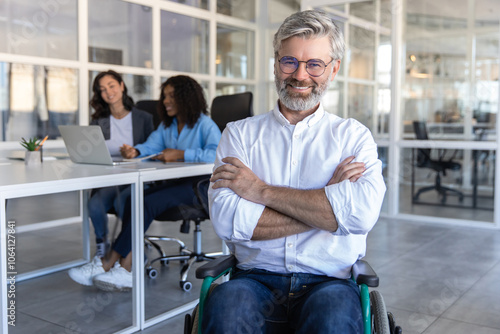 Confident businessman in wheelchair sitting in his modern office