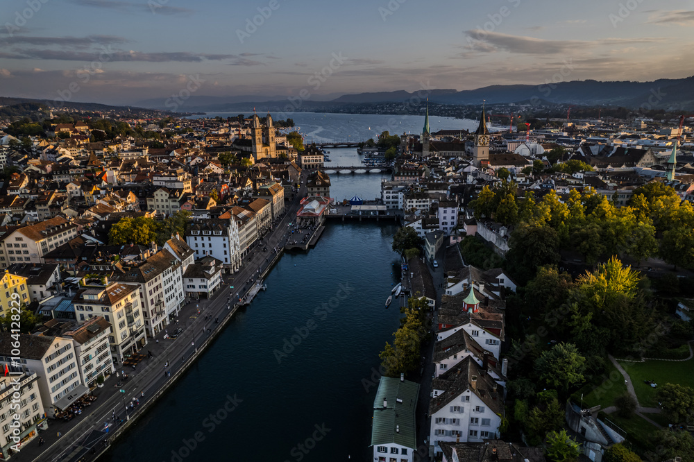 Obraz premium Beautiful aerial view of the city of Zurich in Switzerland - the Limmat River and its iconic churches, buildings rivers and Clockes.