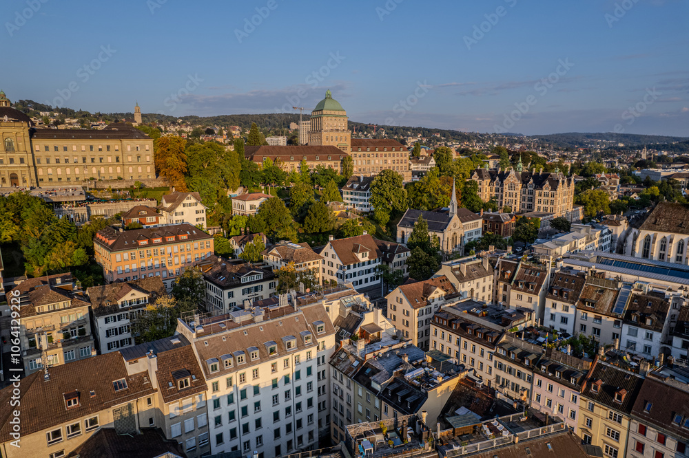 Obraz premium Beautiful aerial view of the city of Zurich in Switzerland - the Limmat River and its iconic churches, buildings rivers and Clockes.