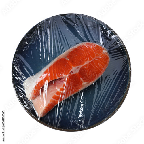 Plate of salmon with plastic food wrap isolated on white, top view photo