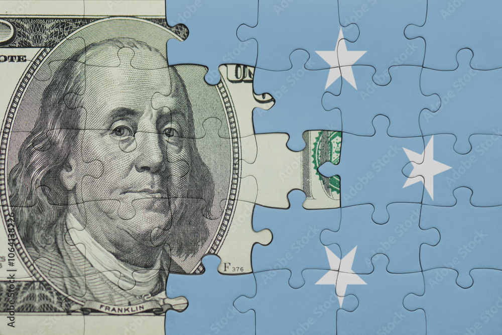 puzzle with the national flag of Federated States of Micronesia and the usa dollar money .finance concept puzzle with the national flag of Federated States of Micronesia and the usa dollar money .finance concept