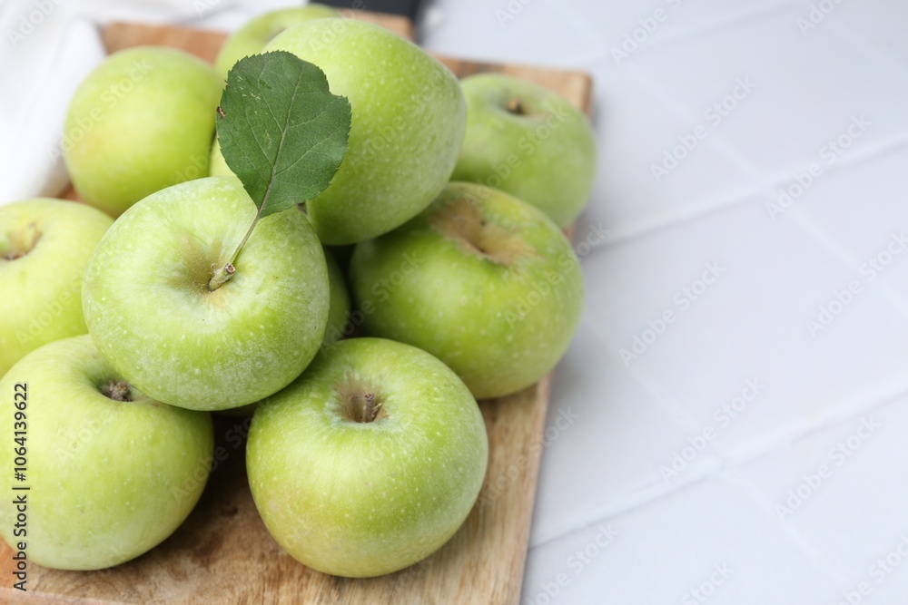 Fresh ripe green apples on white tiled table, closeup. Space for text Fresh ripe green apples on white tiled table, closeup. Space for text