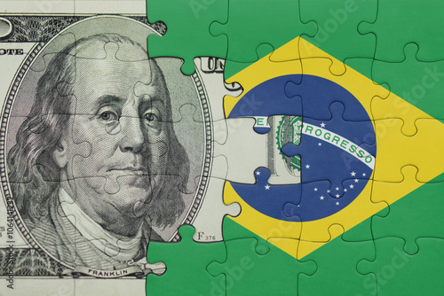 puzzle with the national flag of brazil and the usa dollar money .finance concept photo